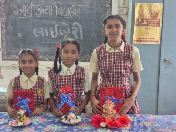 Students showcasing hand-crafted clay Ganpati idols