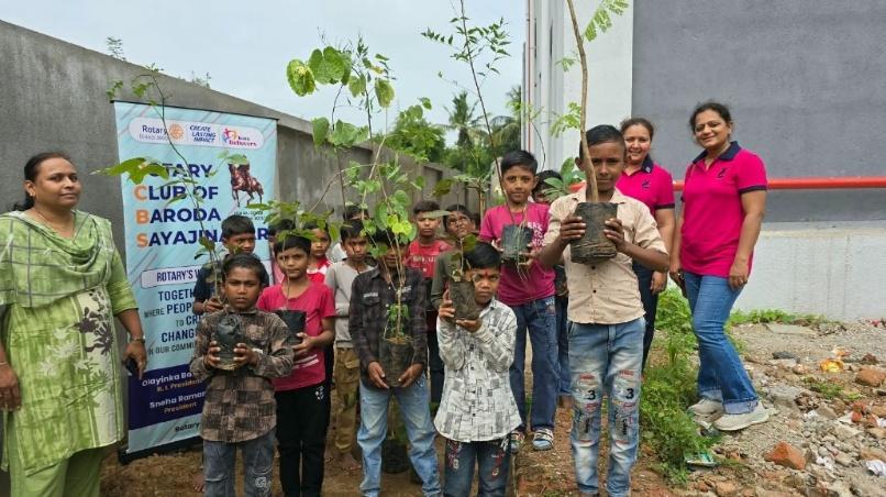 School children proudly holding saplings ready for planting