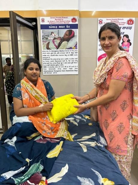 Mother and newborn receiving baby mattress and nourishment