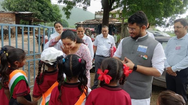 Distributing sweets and sharing fellowship with village children