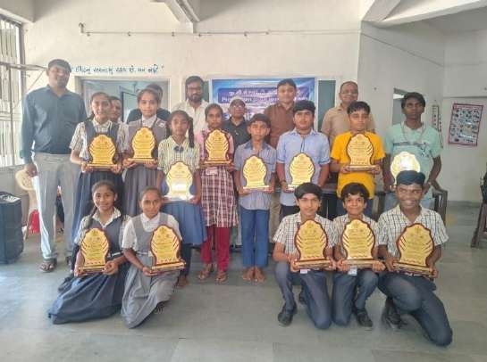 Award ceremony: students holding shields and certificates