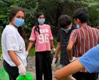 Interactors collecting plastic waste in bags