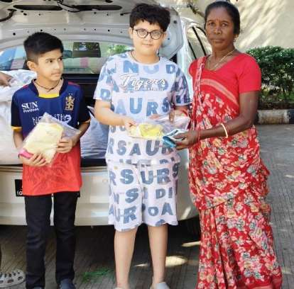 Handing clothes packets to mothers in hospital ward