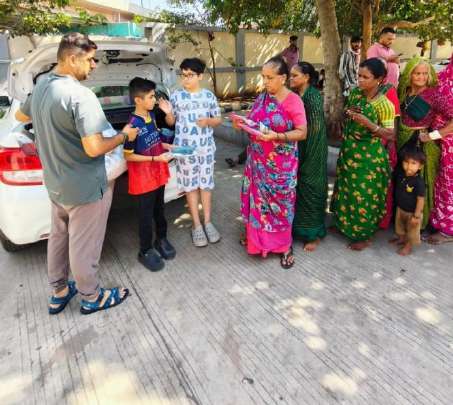 Volunteers distributing infant clothing kits