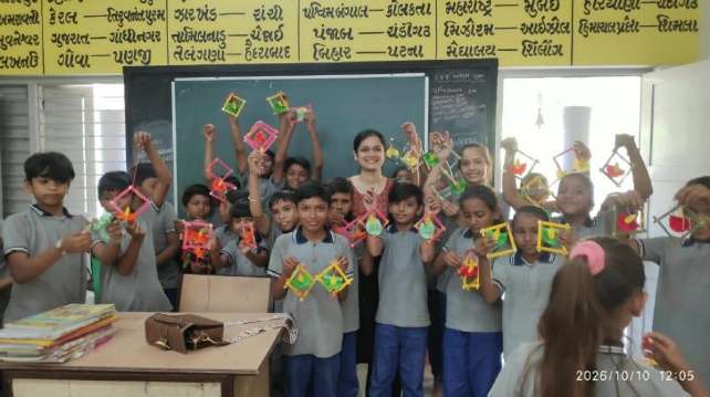 Students displaying handmade paper bags