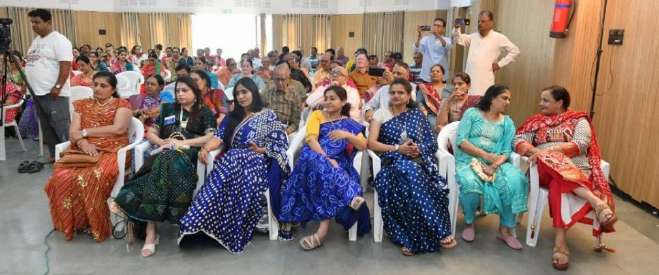 Women in traditional attire singing Betha Garba