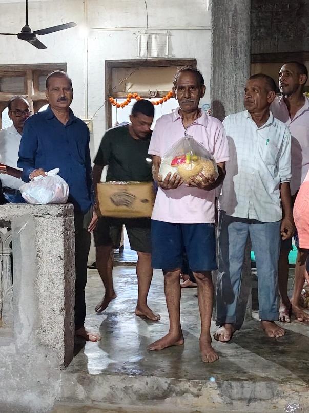Rotarians handing over ration and essentials to beneficiaries