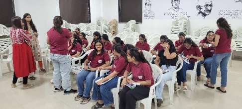 Students and teachers in hall awaiting vaccination